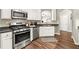 This kitchen offers stainless steel appliances, granite countertops, and ample storage space with stylish white cabinetry at 1119 Brownstone Dr, Marietta, GA 30008