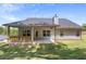Spacious backyard with covered patio, perfect for outdoor gatherings and enjoying the green scenery at 141 Lynn Top Rdg, Dallas, GA 30157