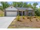 Charming single-story home with a two-car garage and beautifully landscaped front yard at 141 Lynn Top Rdg, Dallas, GA 30157