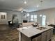 Modern open concept kitchen with granite countertops island and stainless steel appliances at 141 Lynn Top Rdg, Dallas, GA 30157