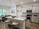 Well-equipped kitchen with a granite island, modern appliances, and a dining area at 141 Lynn Top Rdg, Dallas, GA 30157