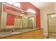 Bathroom featuring granite countertops, double sinks and a glass enclosed shower at 390 17Th Nw St # 2024, Atlanta, GA 30363