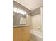 Bright bathroom featuring granite countertop, tile surround and modern fixtures at 390 17Th Nw St # 2024, Atlanta, GA 30363