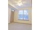 Bedroom features neutral carpet, ceiling fan and natural light from the window at 390 17Th Nw St # 2024, Atlanta, GA 30363