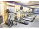 Modern gym equipped with treadmills, ellipticals, and flat screen tv for a complete workout experience at 390 17Th Nw St # 2024, Atlanta, GA 30363