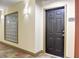 Apartment hallway featuring a black door and a textured glass window for added privacy at 390 17Th Nw St # 2024, Atlanta, GA 30363