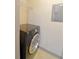 Laundry room with black washing machine, white walls and wire shelving at 390 17Th Nw St # 2024, Atlanta, GA 30363