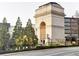 Monumental stone archway framed by mature trees and street lights, evoking timeless architecture at 390 17Th Nw St # 2024, Atlanta, GA 30363