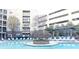 Community pool featuring lounge chairs, shade structure and gas fireplace at 390 17Th Nw St # 2024, Atlanta, GA 30363