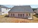 Rear exterior featuring a gray roof, a cozy patio and a light-colored siding at 6902 Winchester Pl, Fairburn, GA 30213