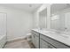 Well-lit bathroom showcasing double vanities, framed mirrors, and a toilet at 6902 Winchester Pl, Fairburn, GA 30213