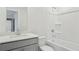 Bright bathroom featuring a shower-tub combo, single vanity, and tile flooring at 6902 Winchester Pl, Fairburn, GA 30213