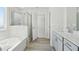 Bright bathroom with a tub, shower, and dual vanities at 6902 Winchester Pl, Fairburn, GA 30213