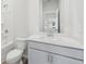 Clean bathroom featuring white fixtures, a toilet, a shower, and a sink with a vanity at 6902 Winchester Pl, Fairburn, GA 30213