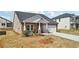 Lovely single Gathering home with stone and white accents and a two car garage at 6902 Winchester Pl, Fairburn, GA 30213