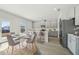 Cozy kitchen nook with modern decor, a round table and chairs, and a view of the backyard at 6902 Winchester Pl, Fairburn, GA 30213