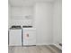 Laundry room with washer, dryer, and wire shelving at 6902 Winchester Pl, Fairburn, GA 30213