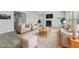 Staged living room showcasing fireplace, neutral furniture and hardwood flooring at 6902 Winchester Pl, Fairburn, GA 30213