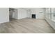 Bright living room featuring a fireplace, wood floors, and lots of light at 6902 Winchester Pl, Fairburn, GA 30213