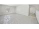 Spacious loft area with neutral walls, carpeted floors, and a window for natural light at 6902 Winchester Pl, Fairburn, GA 30213