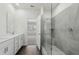 Bathroom with a double vanity sink, tiled shower, and an entry door to bedroom at 7758 Sheffield Ter, Fairburn, GA 30213