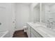 Bright bathroom featuring double sinks, wood floors, and a shower-tub combo at 7758 Sheffield Ter, Fairburn, GA 30213