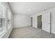 Bright bedroom featuring neutral walls, plush carpet, and a sunlit window at 7758 Sheffield Ter, Fairburn, GA 30213