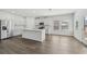 Modern kitchen with stainless steel appliances, white cabinets, and a large kitchen island at 7758 Sheffield Ter, Fairburn, GA 30213