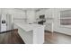 Bright, white kitchen with stainless steel appliances and kitchen island at 7758 Sheffield Ter, Fairburn, GA 30213