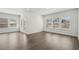 Bright living room with hardwood floors, multiple windows, and a door to the patio at 7758 Sheffield Ter, Fairburn, GA 30213