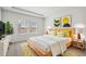 Decorated main bedroom with a bed, bedside tables, and green plants for a modern look at 7758 Sheffield Ter, Fairburn, GA 30213