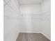 Spacious walk-in closet featuring extensive shelving for optimal storage at 7758 Sheffield Ter, Fairburn, GA 30213