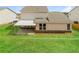 An exterior view showcases the home's covered patio, stone accents, and spacious backyard at 1340 Slaton Manor Dr, Conyers, GA 30012