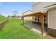 Backyard features a covered patio, green grass and home's exterior at 1340 Slaton Manor Dr, Conyers, GA 30012