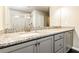 Bathroom featuring dual sink vanity, granite countertop, and marble shower at 1340 Slaton Manor Dr, Conyers, GA 30012