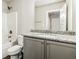 Bathroom with granite countertop, modern fixtures, and neutral cabinets at 1340 Slaton Manor Dr, Conyers, GA 30012