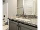 Bathroom features a granite countertop vanity and shower-tub combo at 1340 Slaton Manor Dr, Conyers, GA 30012