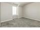 Neutral bedroom featuring plush gray carpet, a window, and light, neutral walls at 1340 Slaton Manor Dr, Conyers, GA 30012