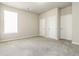 Bedroom featuring neutral paint, plush carpet, and two closets at 1340 Slaton Manor Dr, Conyers, GA 30012