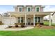 Charming two-story home featuring a welcoming front porch with stone accents and a well-manicured lawn at 1340 Slaton Manor Dr, Conyers, GA 30012