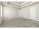 Spacious carpeted main bedroom with tray ceiling and large closet at 1340 Slaton Manor Dr, Conyers, GA 30012