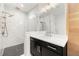 Beautiful bathroom featuring a glass shower, elegant fixtures, black cabinets and marble tiling at 343 Concord St, Alpharetta, GA 30009