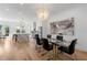 Open-concept dining room featuring a modern chandelier, glass table with seating, and access to an outdoor area at 343 Concord St, Alpharetta, GA 30009