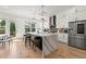 Stylish kitchen boasts a quartz island with seating, stainless steel appliances, and modern cabinetry at 343 Concord St, Alpharetta, GA 30009