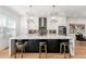 Modern kitchen featuring stainless steel appliances, a large island with seating, and pendant lighting at 343 Concord St, Alpharetta, GA 30009