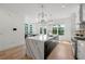 Modern kitchen featuring stainless appliances, a large island, quartz countertops, and stylish lighting at 343 Concord St, Alpharetta, GA 30009