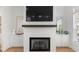 Living room showcases a white brick fireplace with dark mantle, built-in cabinets, and large TV at 343 Concord St, Alpharetta, GA 30009