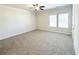 Large bedroom featuring carpet, a ceiling fan, and two windows for natural light at 5096 Cumberland Ct, Villa Rica, GA 30180