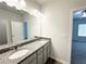 Bathroom vanity featuring double sinks with granite countertop and light fixtures at 5295 Greenway Dr, Villa Rica, GA 30180