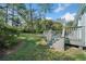 The wooden back deck has railings and stairs down to the grassy lawn at 1467 Thompson Pl, Decatur, GA 30032